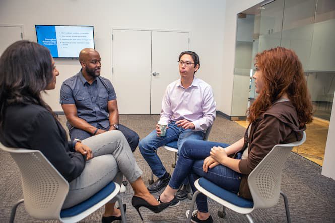 four people in conversation